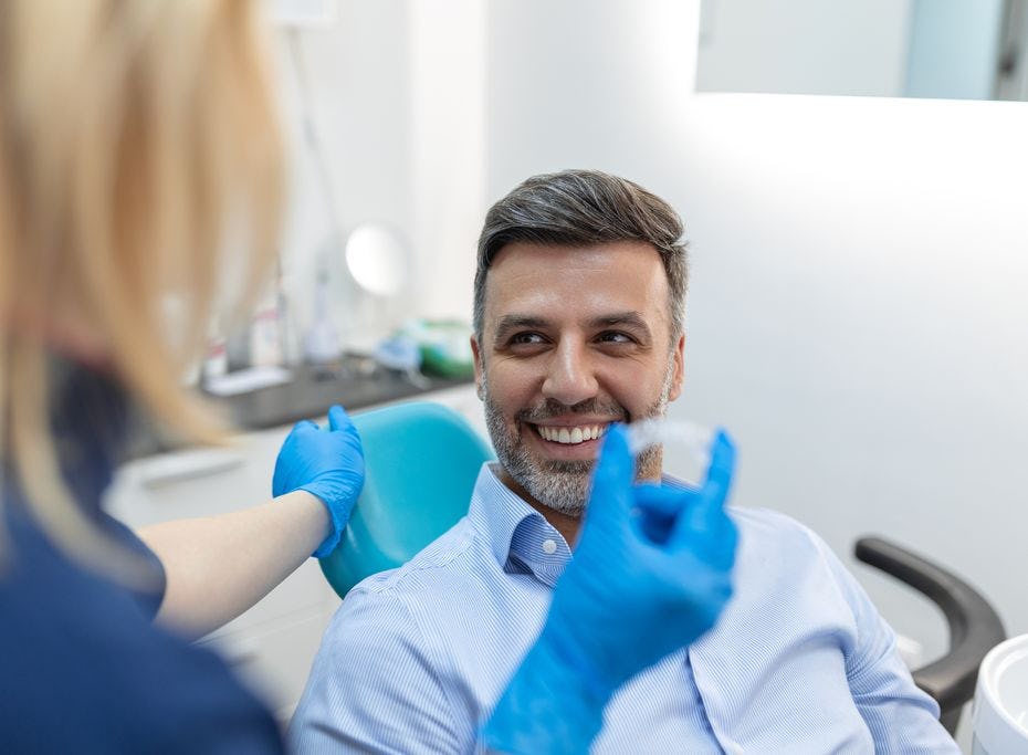 A man in a dental chair about to begin clear aligner treatment