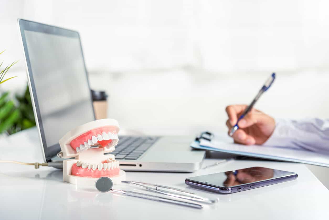 A dentist works on a computer in a dental practice