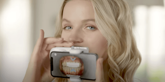 Clear aligners patient using a Scanbox Pro remote monitoring device