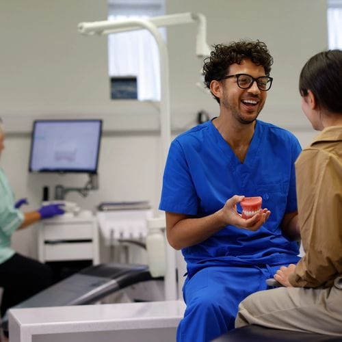 A dental nurse explain oral hygiene to a young patient