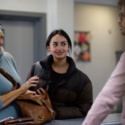 A girl with braces, with her mum, waits at Windmill Orthodontics practice reception