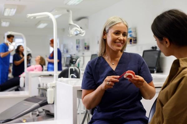 a women holding a bag with the Invisalign logo on it