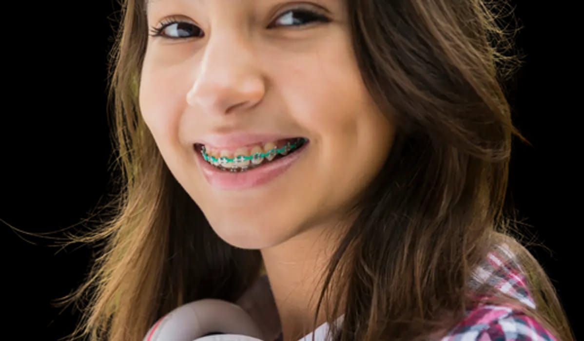 A happy teenage girl with fixed metal braces