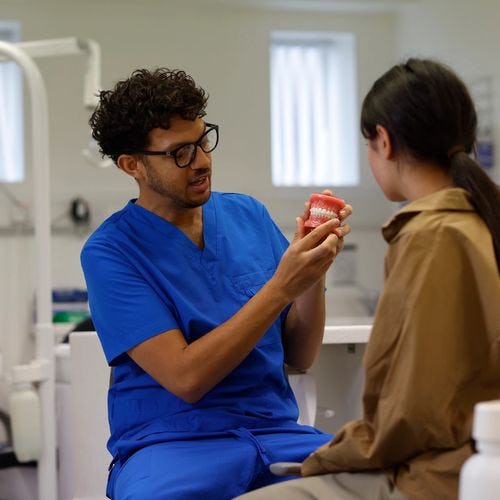 An orthodontic therapist explains NHS treatment to a patient