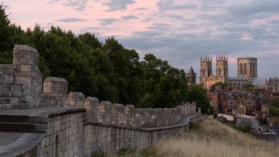 York city walls with York minster in the distance at sunset